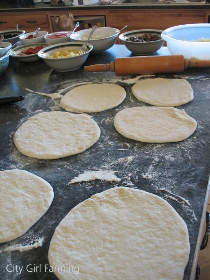 Grilled pizza is a great way to make pizza in the summer when you don’t want to heat up your house. I’ve made it two different ways (cooking it on a pre-heated baking stone placed on your grill, or the way I did it for my sister—cooking it directly on the grill). I prefer the direct grill approach for pizza making because it’s quick and easy and everyone can make their own individual sized pizzas.