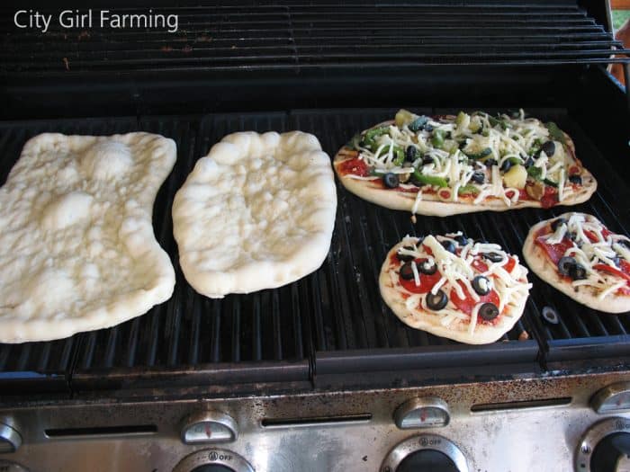 Grilled pizza is a great way to make pizza in the summer when you don’t want to heat up your house. I’ve made it two different ways (cooking it on a pre-heated baking stone placed on your grill, or the way I did it for my sister—cooking it directly on the grill). I prefer the direct grill approach for pizza making because it’s quick and easy and everyone can make their own individual sized pizzas.