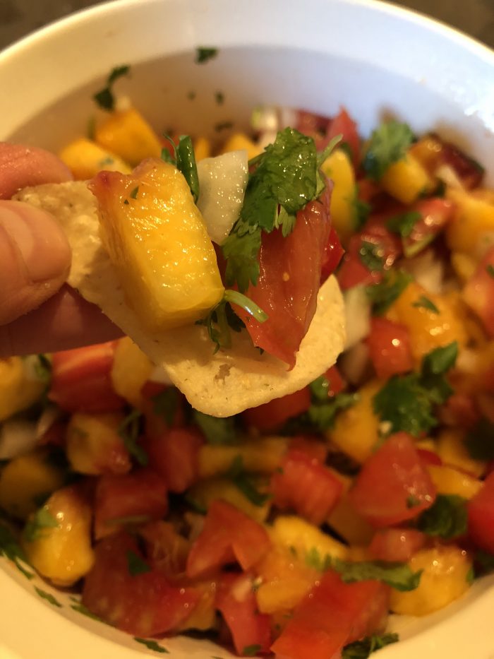 Spicy peach salsa is a perfect peach season recipe. It's a spicy yet sweet take on traditional salsa that's super easy to make and devoured just as quickly. It's a great chip and salsa combo to switch things up a little. But it's also great as an accompaniment to fish, chicken or other meats.