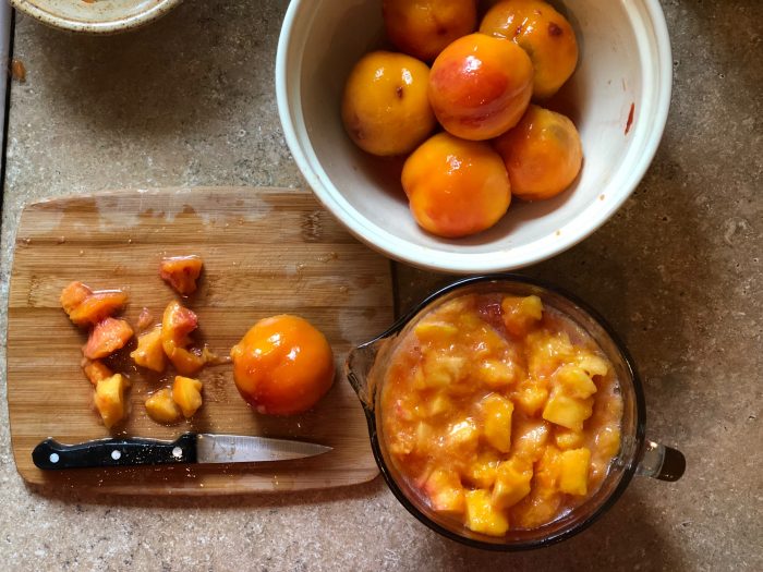 chopping up nectarines for pumpkin spice nectarine jam